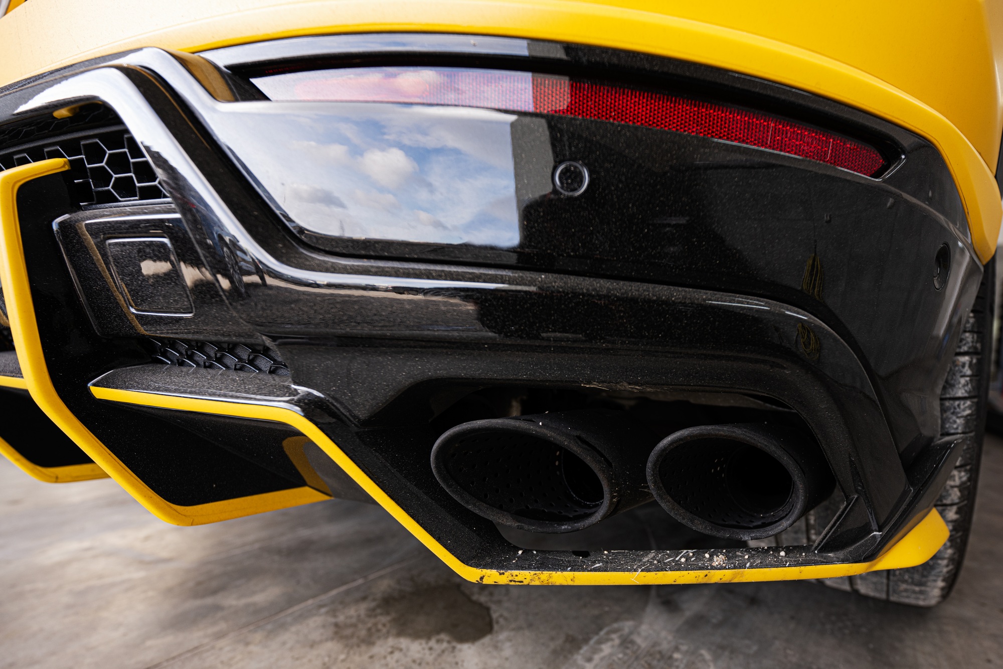Dual exhaust of yellow sport car suv.